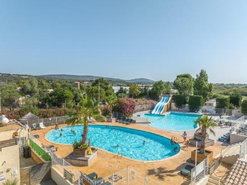 an overhead view of a pool with a water slide at Mobil-Home en camping**** in Vic-la-Gardiole