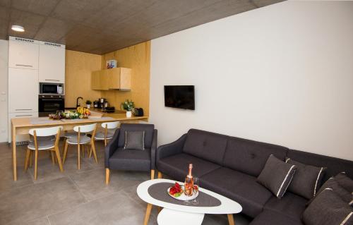 a living room with a couch and a table at Residence Trafick in Prague
