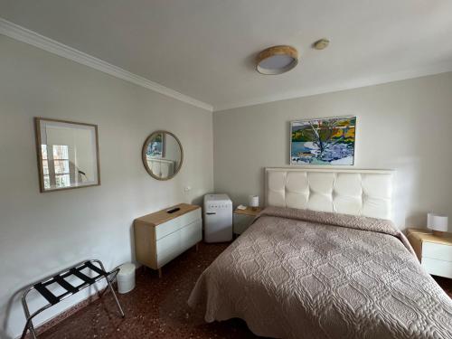 a bedroom with a large bed and a mirror at Hotel Paraíso Del Mar in Nerja