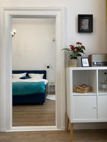 a bedroom with a mirror and a bed in it at Hey Central Apartment in Timişoara