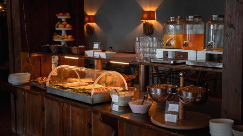 a restaurant with a buffet with food on a counter at Champoussin Lodge in Champoussin