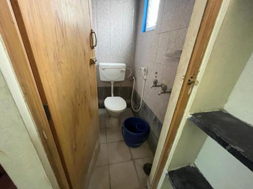 a small bathroom with a toilet in a room at Meera stays in Coimbatore