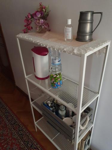 a white shelf with a bottle on top of it at la Bellavita rooms in Caltanissetta