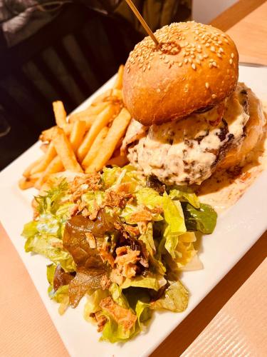 a plate of food with a sandwich and french fries at Restaurant Hôtel du Vercors in Saint-Martin-en-Vercors