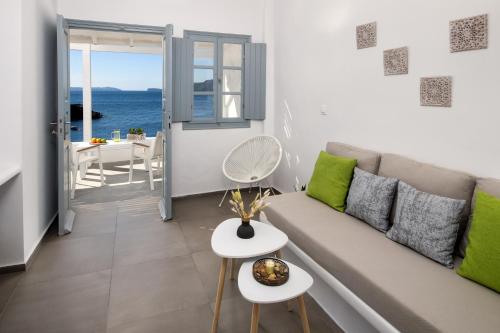 a living room with a couch and a view of the ocean at Lava Stone in Oia