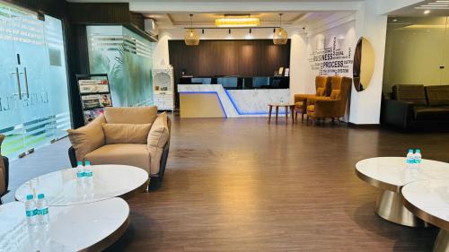 a lobby with tables and chairs and a store at Elite 32 Avenue - Near Google Building in Gurgaon