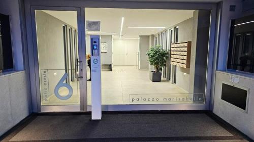an entrance to a building with a door with a sign on it at Azuma Luxury Home in Bari