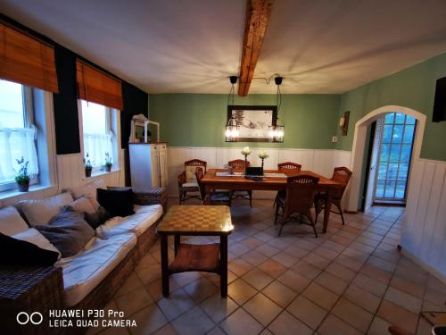 a living room with a couch and a table at Ferienhaus Rennsteig-Wander-Mountainbike und Langlaufparadies in Friedrichshöhe