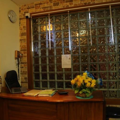 a table with a vase of flowers on top at Madhu Manish Homestay and Rooms in Coonoor