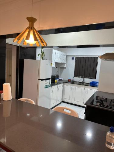 a kitchen with a refrigerator and a counter top at Home Away Comfort stay in Suva
