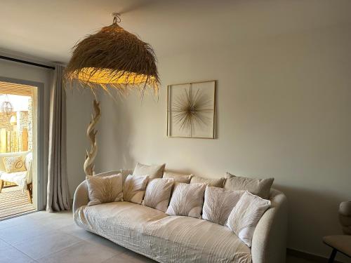 a living room with a white couch in a room at T4 Cala Rossa - 3 Ch - Piscine et Plage à pied in Lecci