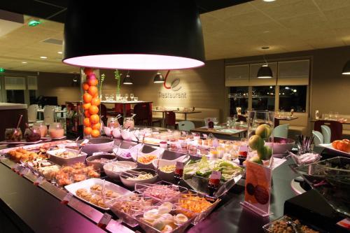 a buffet line with many different food items at Hotel Campanile Besançon Nord Ecole Valentin in Besançon