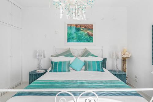 a bedroom with a bed with blue and white pillows at Villa Navarra in Praiano