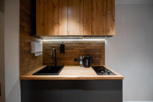a kitchen with a sink and a counter top at Апартаменти MYFREEDOM поруч із метро Чернігівська in Kyiv