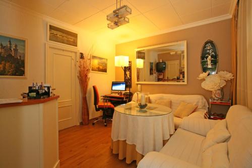 ein Wohnzimmer mit einem weißen Sofa und einem Tisch in der Unterkunft Pension Zurita in Granada