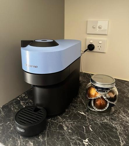 a coffee maker sitting on a counter with some bread at Pond Road Park - Raglan in Raglan