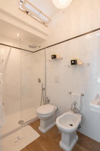 a bathroom with a toilet and a shower and a sink at Villa Navarra in Praiano
