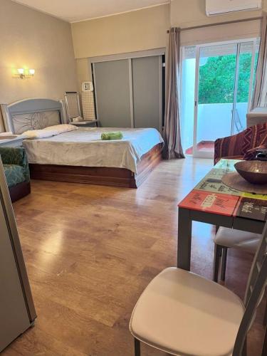 a hotel room with a bed and a table and a table sidx sidx at Studio near the beach in Albufeira