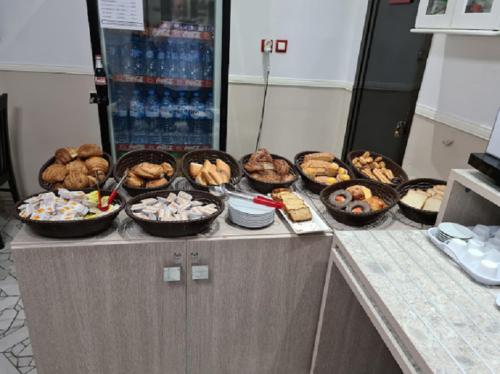 a buffet with bowls of food on a counter at SAMIR HOTEL in Alger