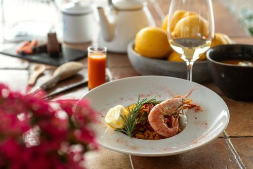 a plate of food with a shrimp on a table at Cuatre Finques in Jalón