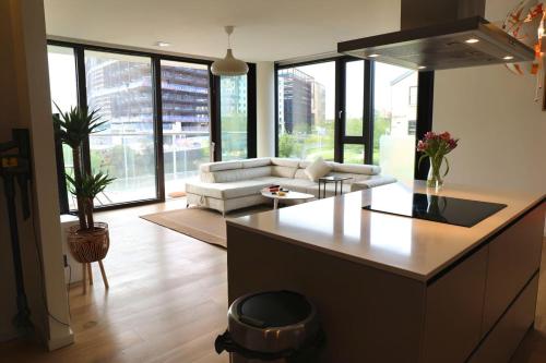 a kitchen and living room with a couch and a table at 2 Bedroom 2 Bathroom Apartment in Kings Cross Station in London