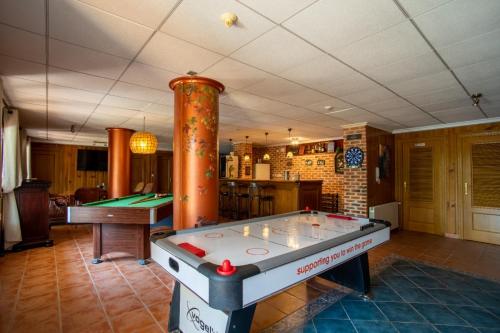 a ping pong table in a room with a pool at 10 Bedroom 5 Star Luxury Villa & Heated Pool for 5 to 28 Guests near Alicante in Mutxamel