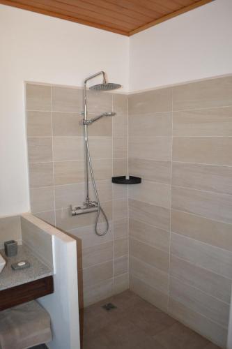 a bathroom with a shower with a shower head at Kily House in Morondava