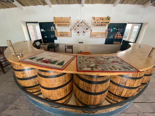 a bar made out of wine barrels in a room at Himalayan Hideaway-TVM in Manāli