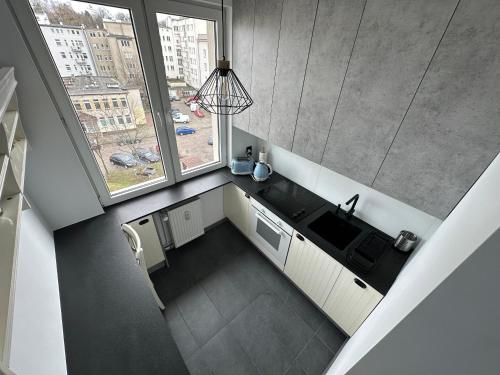 an overhead view of a kitchen with a sink and a window at Eros Gdynia, Śródmieście in Gdynia