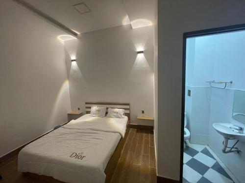 a small room with a bed and a sink at Ngoc An Hotel in Tây Ninh