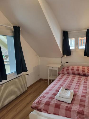 a bedroom with a bed with a checkered blanket at Interlaken Apartments in Interlaken