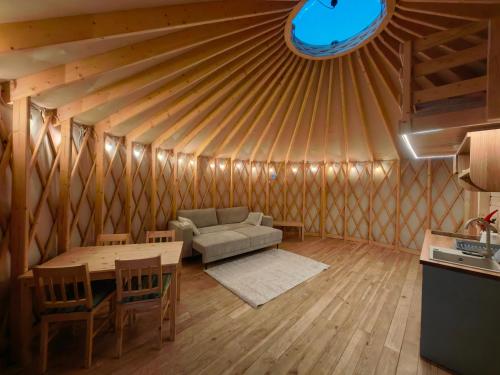 a living room with a couch and a table in a yurt at Owcza Jurta in Dursztyn