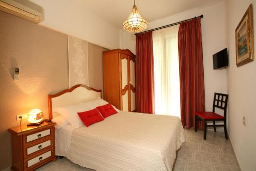 a bedroom with a bed and a window with a red curtain at Pension Zurita in Granada