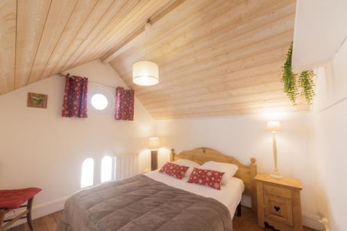 En eller flere senge i et værelse på Domaine de l’Orangerie - Le Colombier