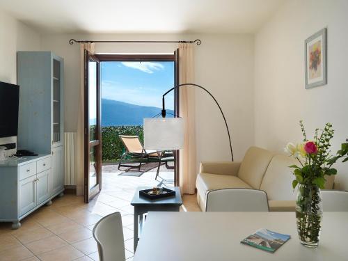 a living room with a couch and a table at Residence Besass, GTSGroup in Tignale