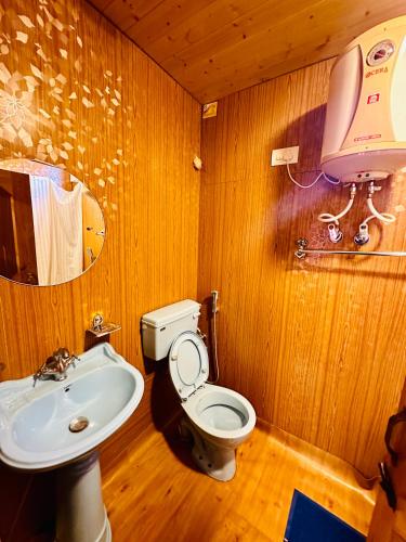 a bathroom with a toilet and a sink at Houseboat New world in Srinagar