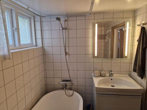 a bathroom with a sink and a toilet and a mirror at Studio 11 in Surte