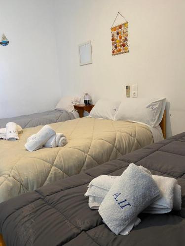 two beds sitting next to each other in a room at Alexandra Studios in Néos Pírgos
