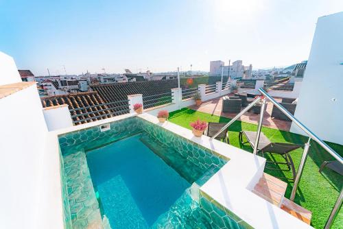 a swimming pool on the roof of a building at Casa San Mateo in Córdoba