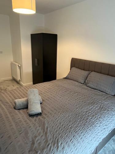een slaapkamer met een groot bed en een zwarte kast bij Lovely Private double room in Barking