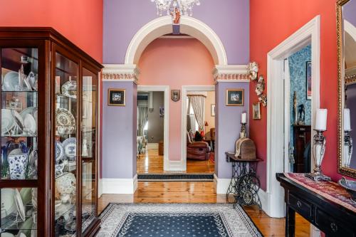 a hallway with pink and purple walls at The Red Door: Expansive Home/Pool/4 BR w Ensuites in Glenelg