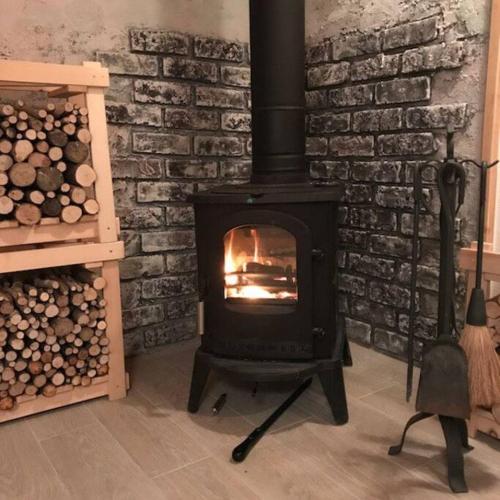 a fireplace in a room with a brick wall at Kitakaruizawa Morino Bessou NO8 in Tsumagoi