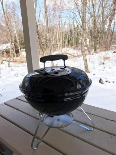 a grill sitting on a porch in the snow at Kitakaruizawa Morino Bessou NO8 in Tsumagoi