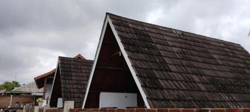 a large building with a brown roof at Nan Bungalows Tetebatu in Tetebatu