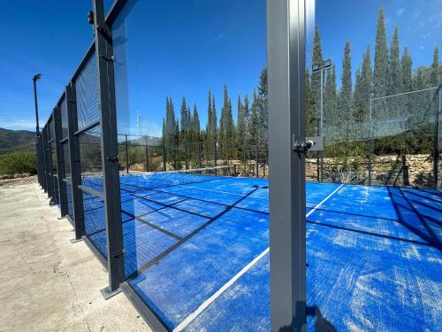 a tennis court with a net on it at Finca Dariana Padel & Pool in Alora