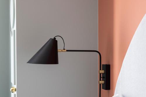 a black lamp sitting next to a door at LE CLARK HOTEL in Paris