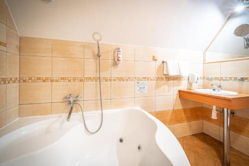 奧斯特拉維採的住宿－Bungalovy Sepetná，浴室配有白色浴缸和水槽