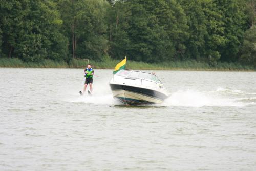 a man is on a boat in the water at Sodyba Brazylija in Taraldžiai