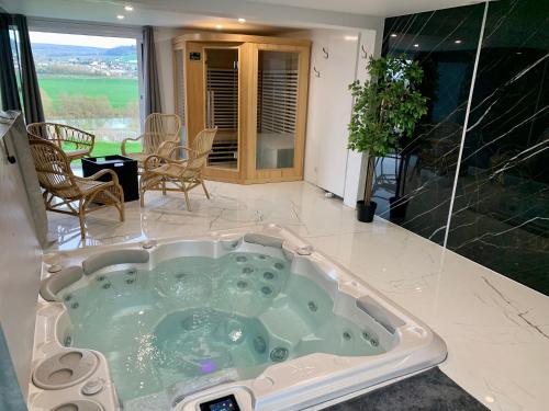 a jacuzzi tub in the middle of a room at Le Spanorama; gîte premium in Vincelles