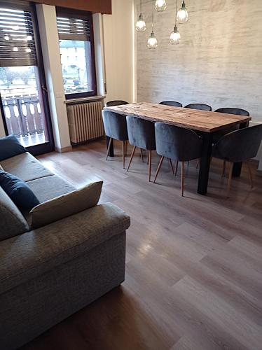 a dining room with a table and chairs and a couch at Asiago Plateau New Modern House in Asiago